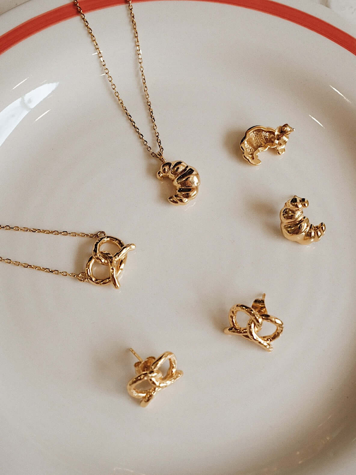 Minimalist vintage 18k gold vermeil jewelry set on plate. Elegant and romantic everyday luxury earrings and necklace. Affordable style.
