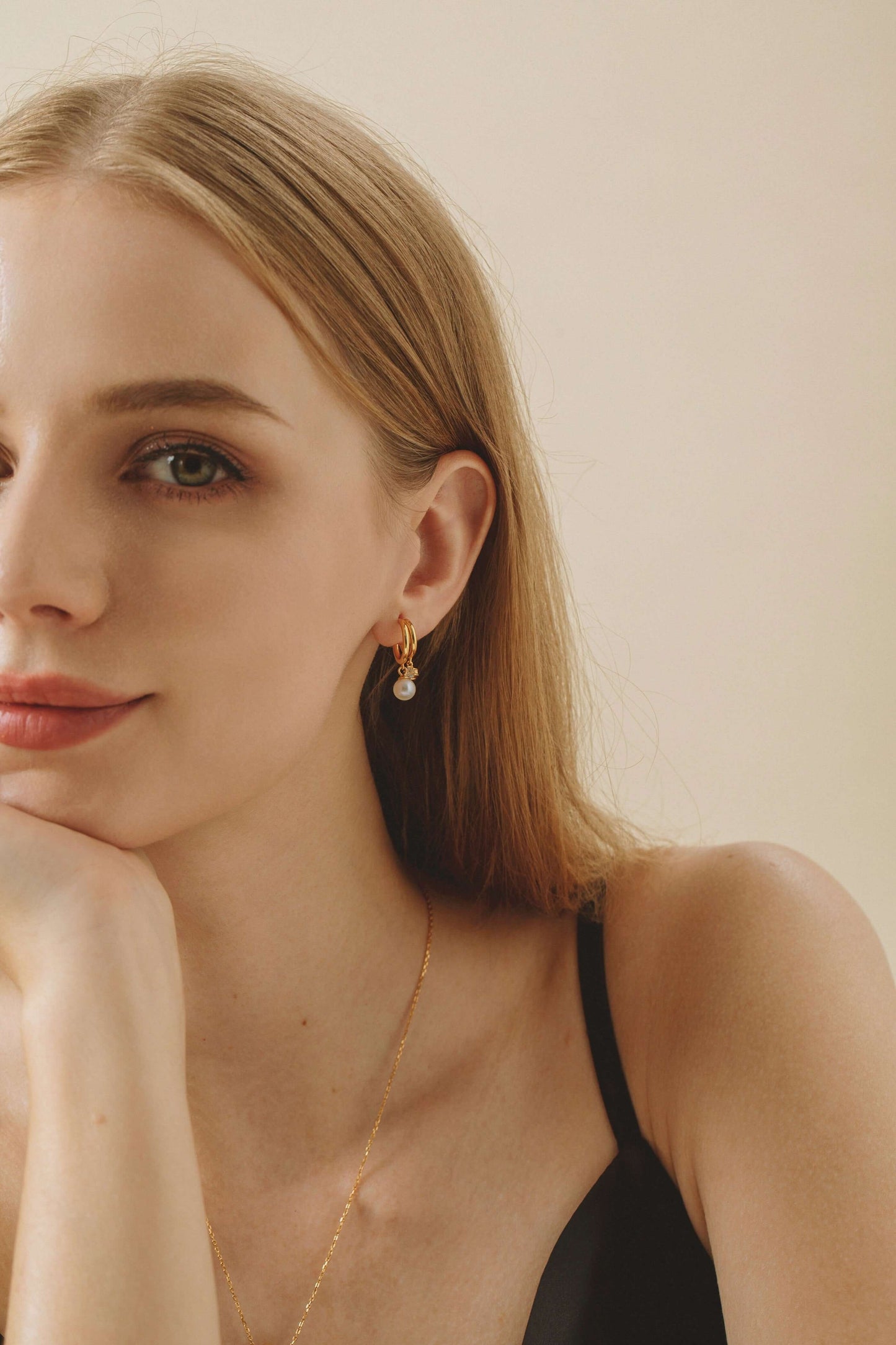 "Allure" Freshwater Pearl Earrings by SUIHE Jewelry in gold vermeil with zircon stones, worn by model. Elegant and sophisticated design.