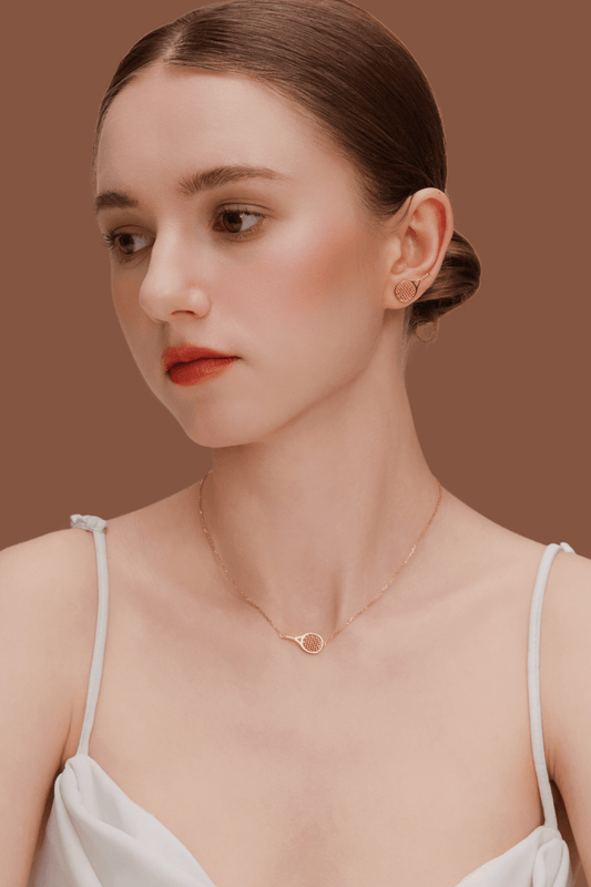 Model wearing SUIHE Jewelry Tennis Necklace with gold-plated tennis racket pendant, showcasing sporty chic elegance.