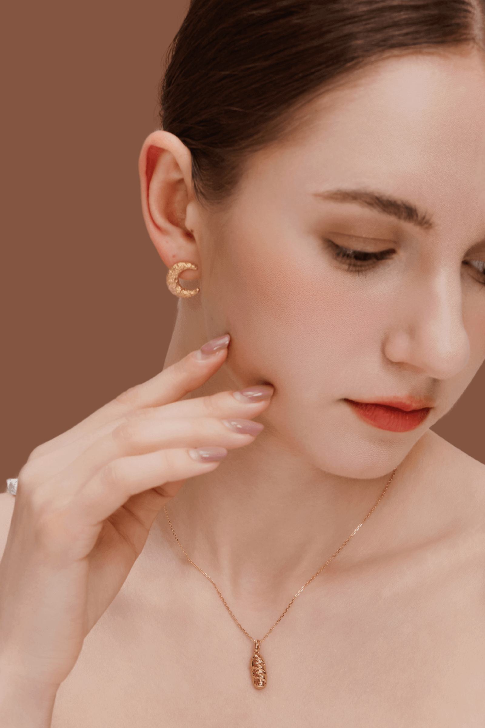 Woman wearing SUIHE Jewelry's Moon Necklace with crescent moon pendant and matching gold plated earrings.