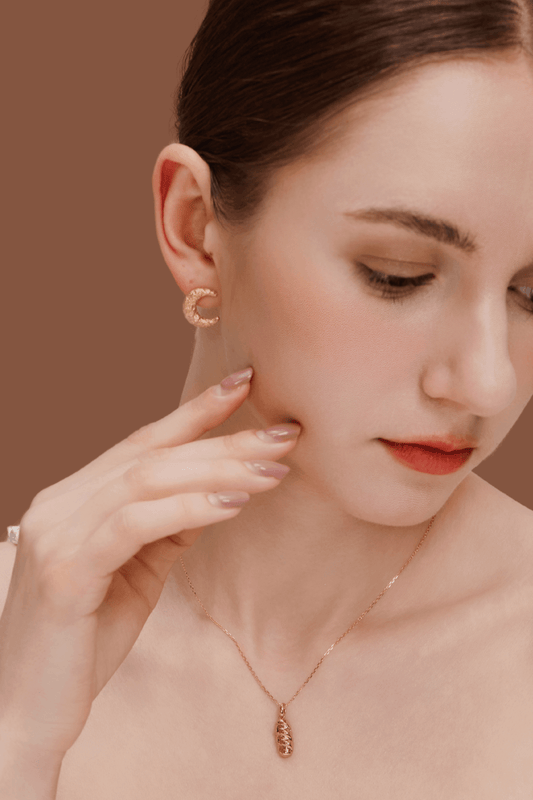 Woman wearing SUIHE Jewelry's Moon Necklace with crescent moon pendant and matching gold plated earrings.