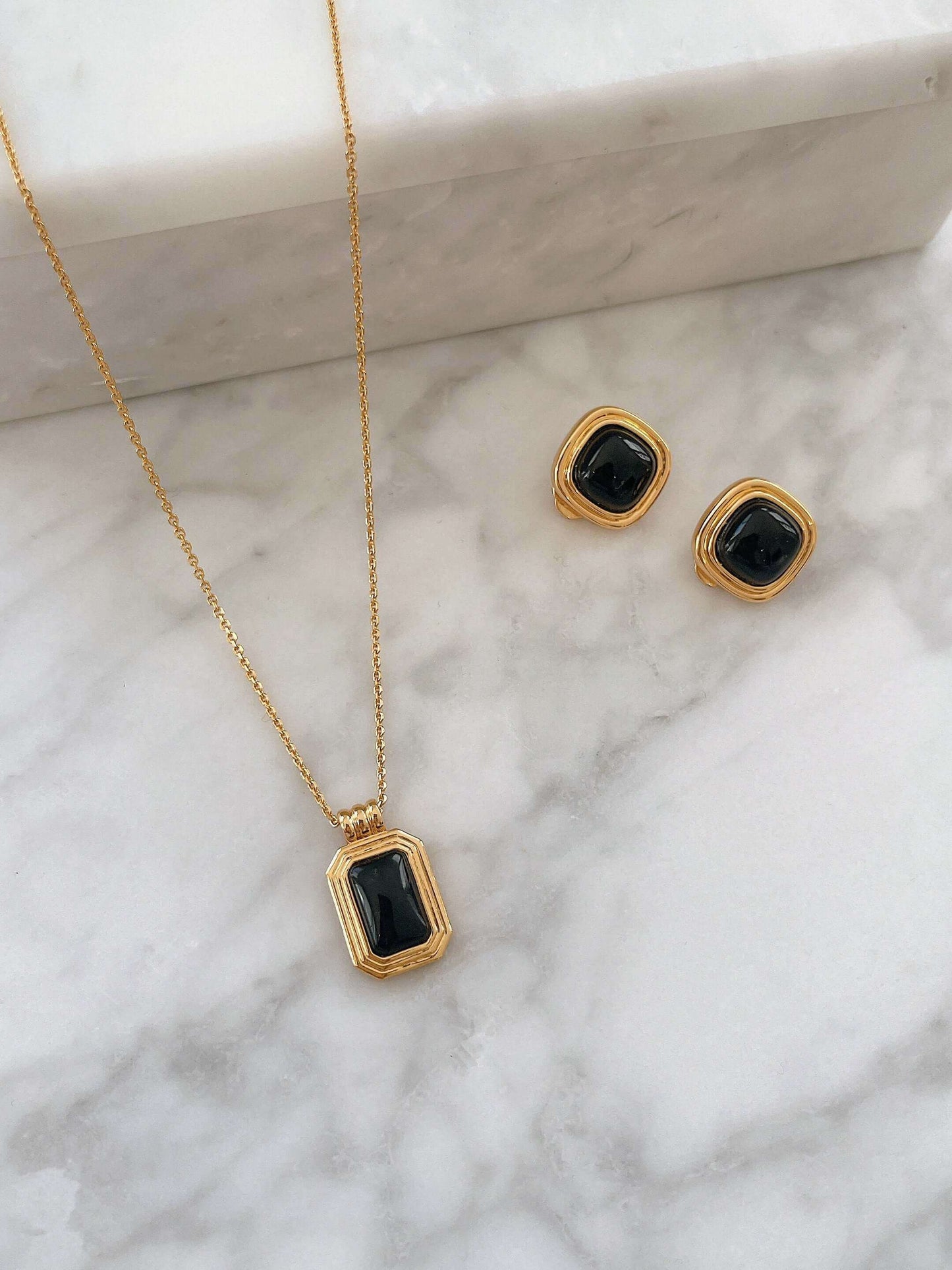 Nocturne black onyx rectangle necklace with matching earrings in 18k gold vermeil over sterling silver by SUIHE Jewelry on marble.
