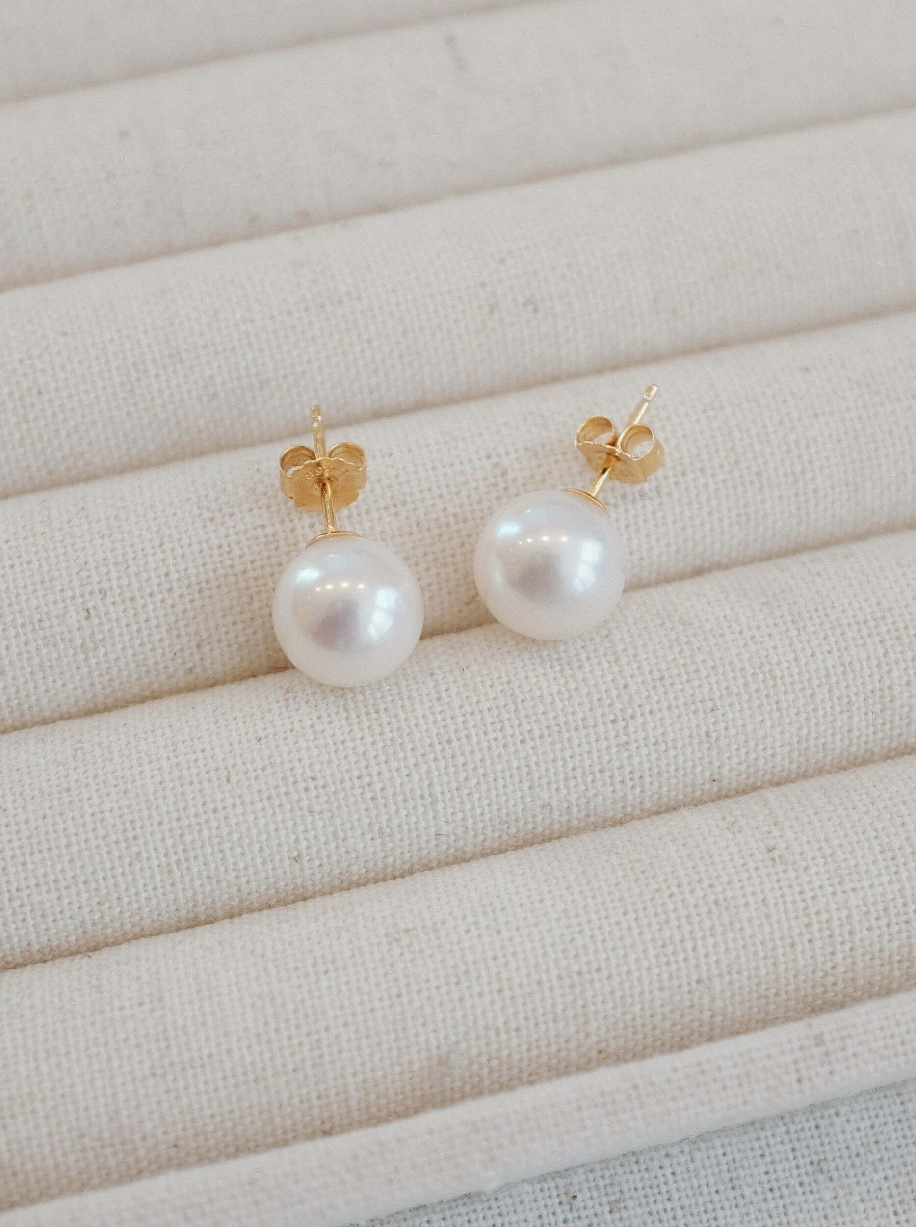SUIHE Jewelry "Aurora" Akoya Pearl Stud Earrings in 18k Gold Vermeil on cream display
