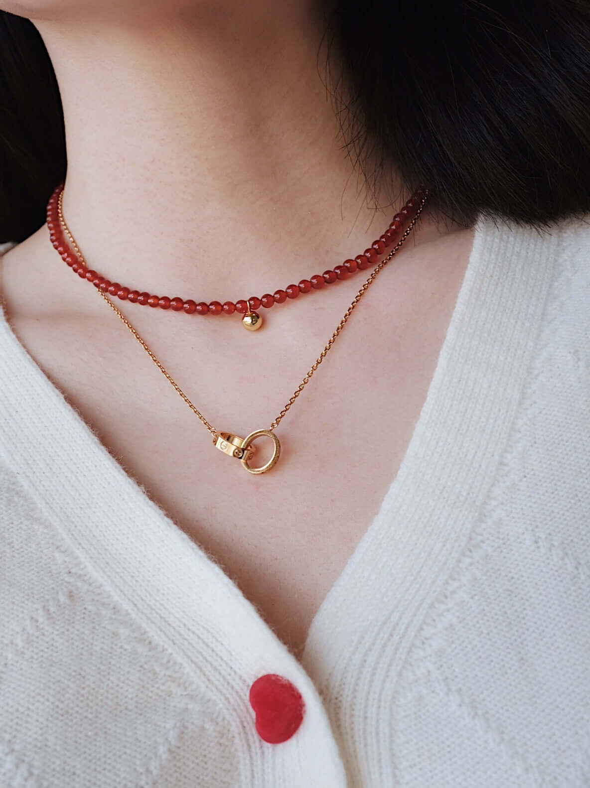"Lucky" Red Agate Gemstone Necklace by SUIHE Jewelry, featuring vibrant red agate beads and 18k Gold Vermeil, worn on a woman's neck.