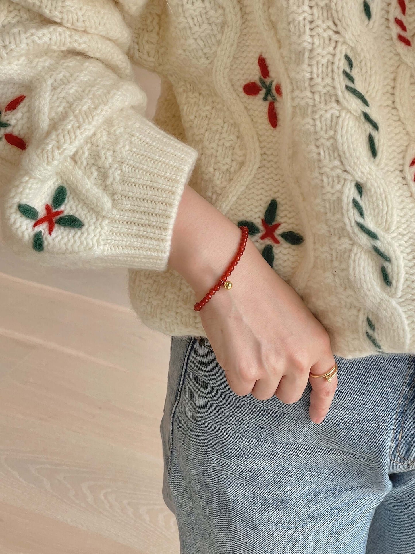 Person wearing SUIHE Jewelry 'Lucky' Red Agate Gemstone Bracelet with 18k Gold Vermeil, symbolizing hope and fortune.