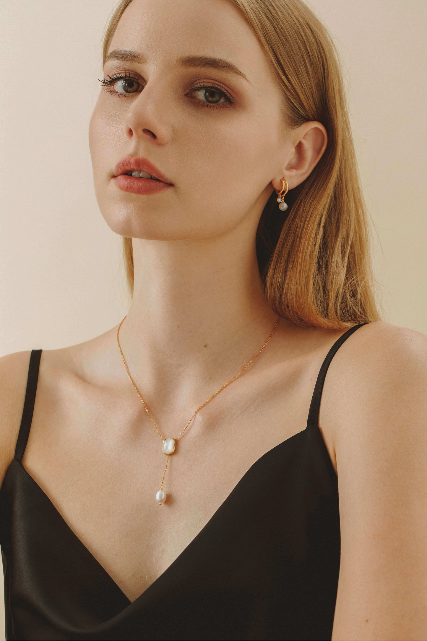 Woman wearing "Allure" Mother-Of-Pearl and Pearl Drop Necklace by SUIHE Jewelry, featuring modern elegance with timeless design.