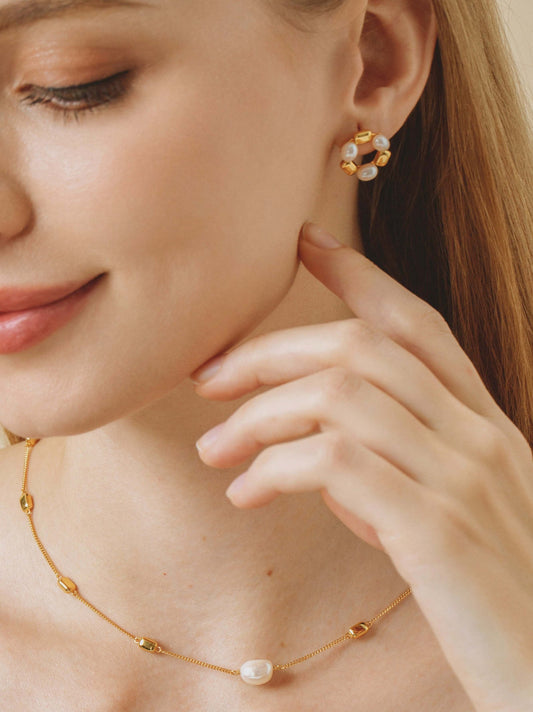 Woman wearing SUIHE Jewelry Jellybean Pearl Hoop Earrings and necklace, featuring freshwater pearls and gold accents.