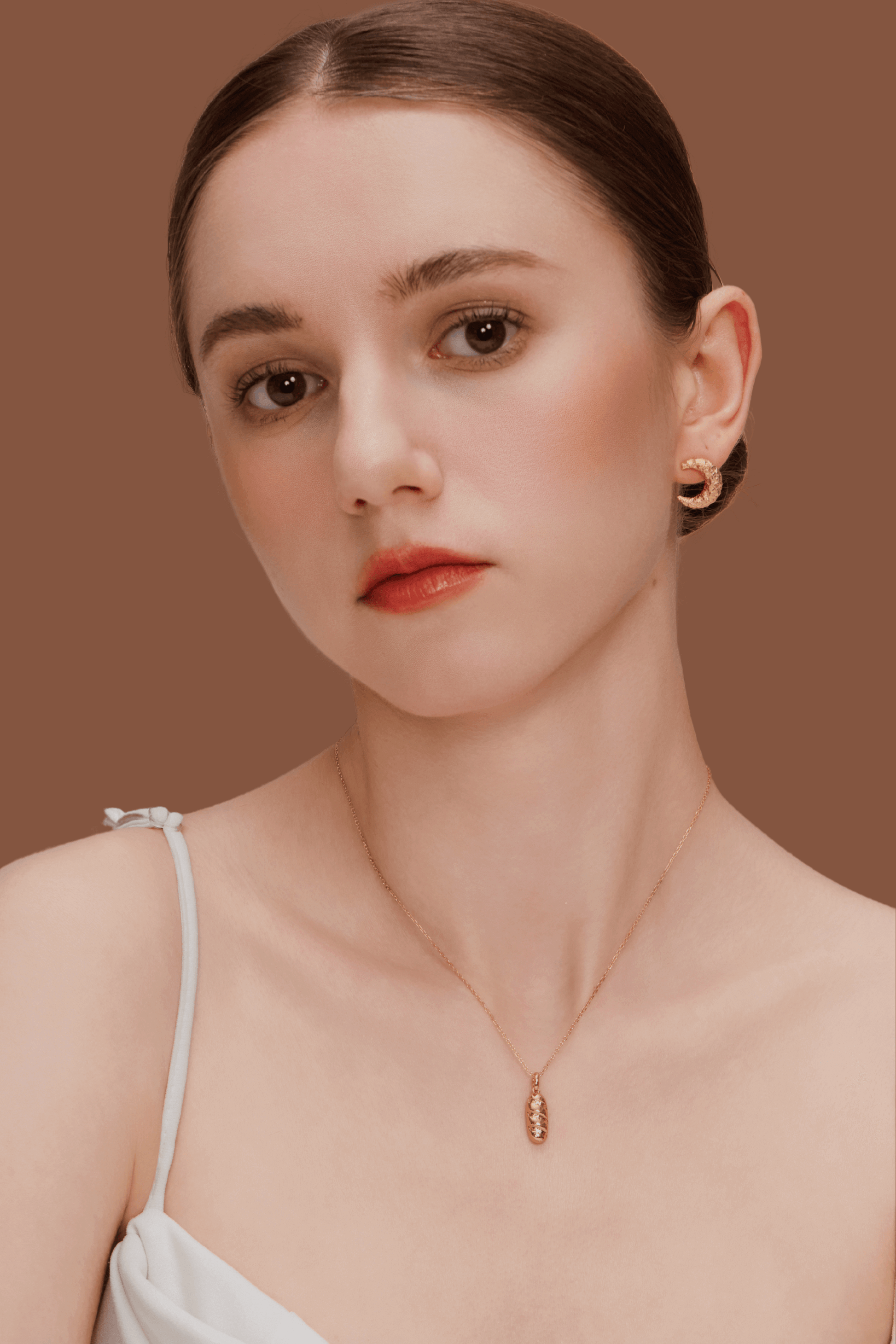 Woman wearing SUIHE Jewelry's "Moon" Necklace in gold with crescent moon pendant, symbolizing intuition and feminine energy.