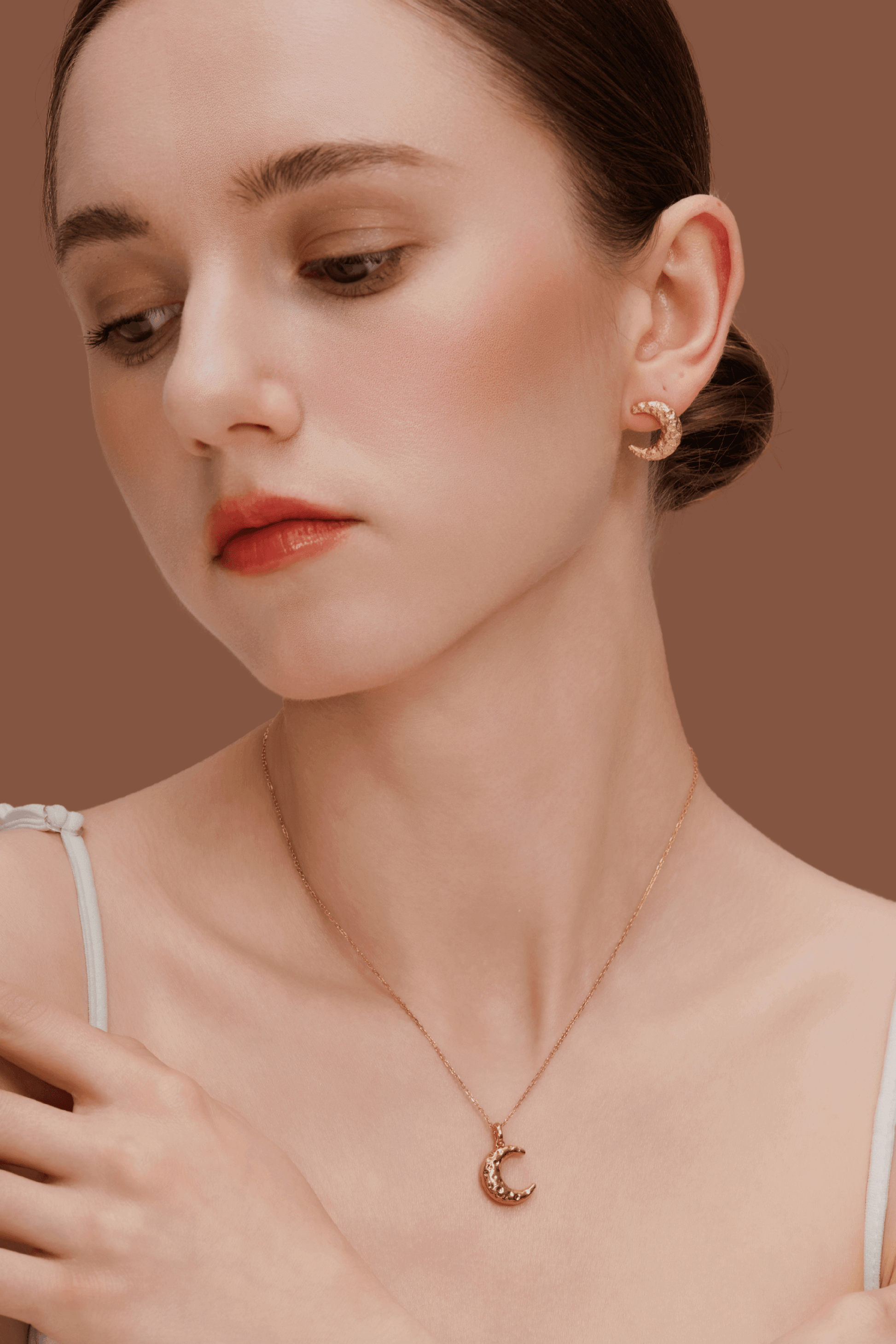 Woman wearing SUIHE Jewelry Moon Necklace and crescent earrings, showcasing celestial elegance with gold plating and textured crescent design.