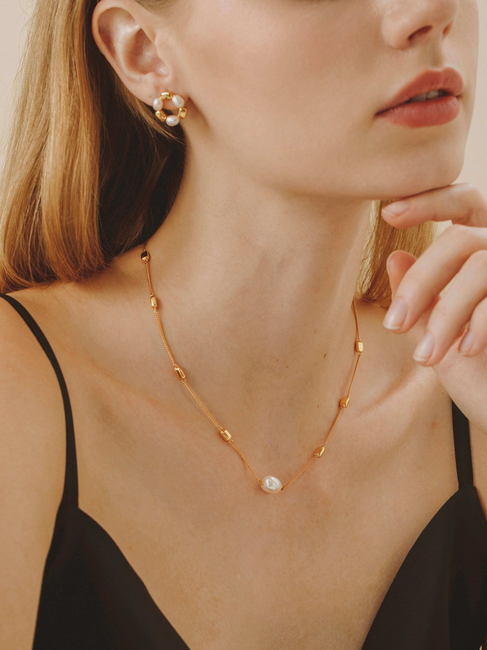 Jellybean Necklace by SUIHE Jewelry with gold vermeil and freshwater pearls, styled on a model, showcasing elegant and versatile design.