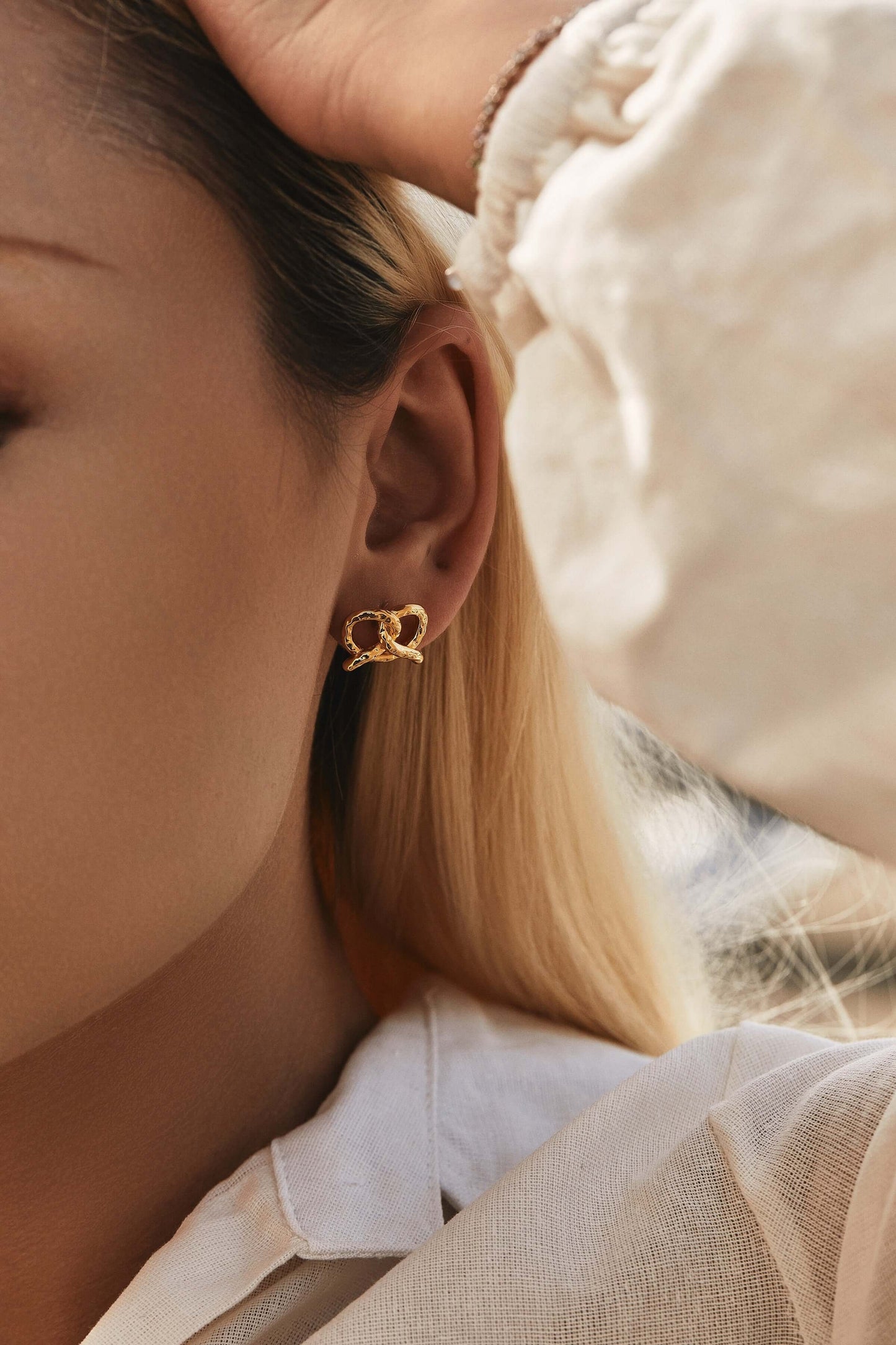 Close-up of model wearing SUIHE Jewelry's "Pretzel" Stud Earrings in 18k Gold Vermeil, capturing elegance and sophistication.