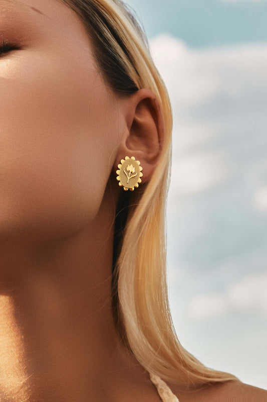 Woman wearing 'Golden Tulip' clip earrings by SUIHE Jewelry, featuring 18k gold vermeil design with floral elegance.