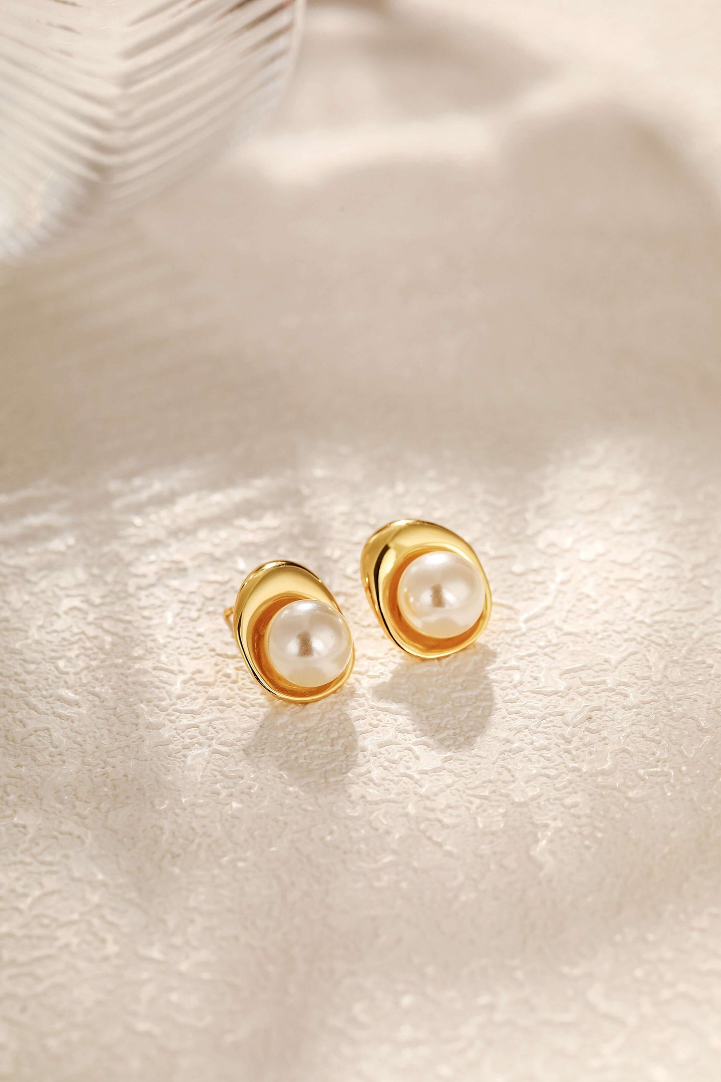 "Elysian" Freshwater Pearl Stud Earrings in 18k Gold Vermeil by SUIHE Jewelry on textured surface