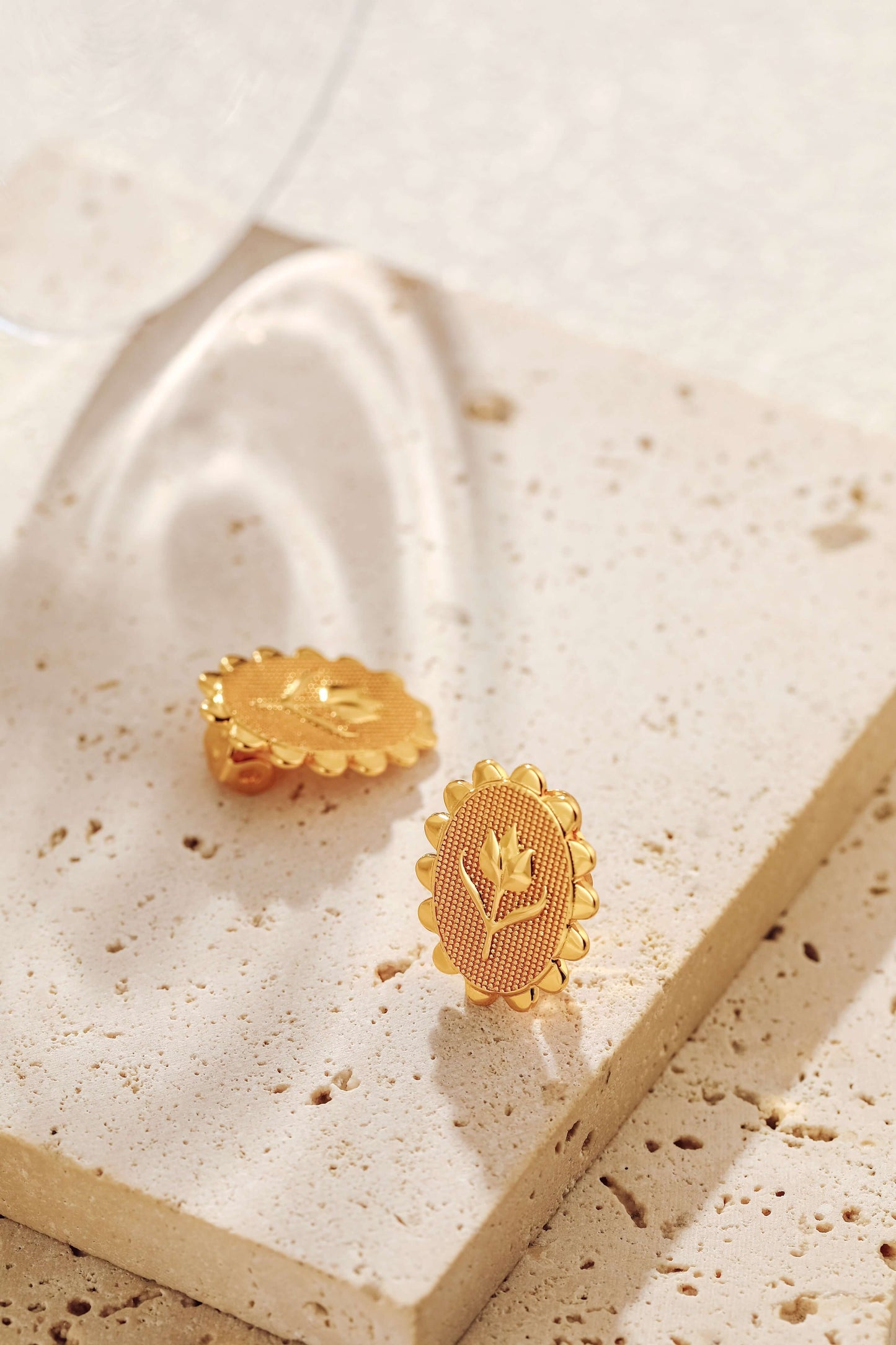 Golden Tulip Clip Earrings by SUIHE Jewelry on stone surface, crafted in 18k Gold Vermeil, embodying spring elegance and grace.