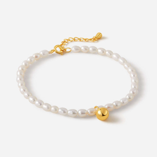 "Celestia Freshwater Pearl Bracelet by SUIHE Jewelry featuring luminous pearls, gold-tone charm, and adjustable clasp on white background"