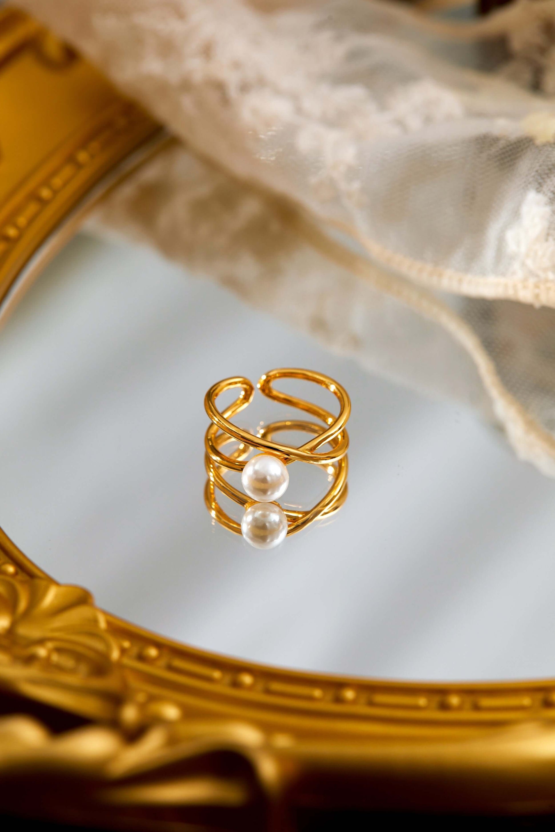 Wavelet Freshwater Pearl Ring by SUIHE Jewelry on ornate mirror, features gold-tone wave band with lustrous pearl, elegant design