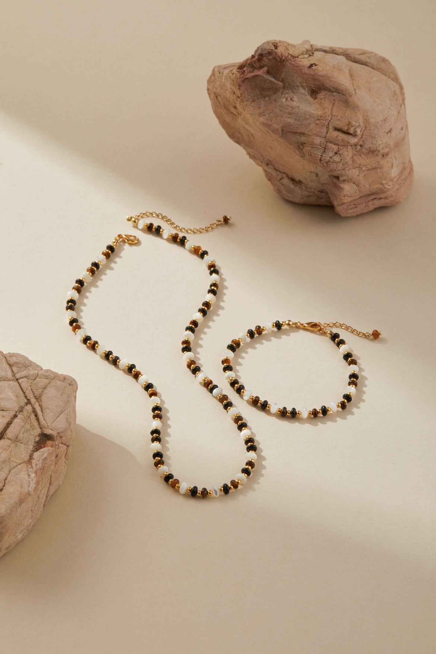SUIHE Jewelry Marble Natural Gemstone Necklace with pearls and gold-tone accents on a beige background.