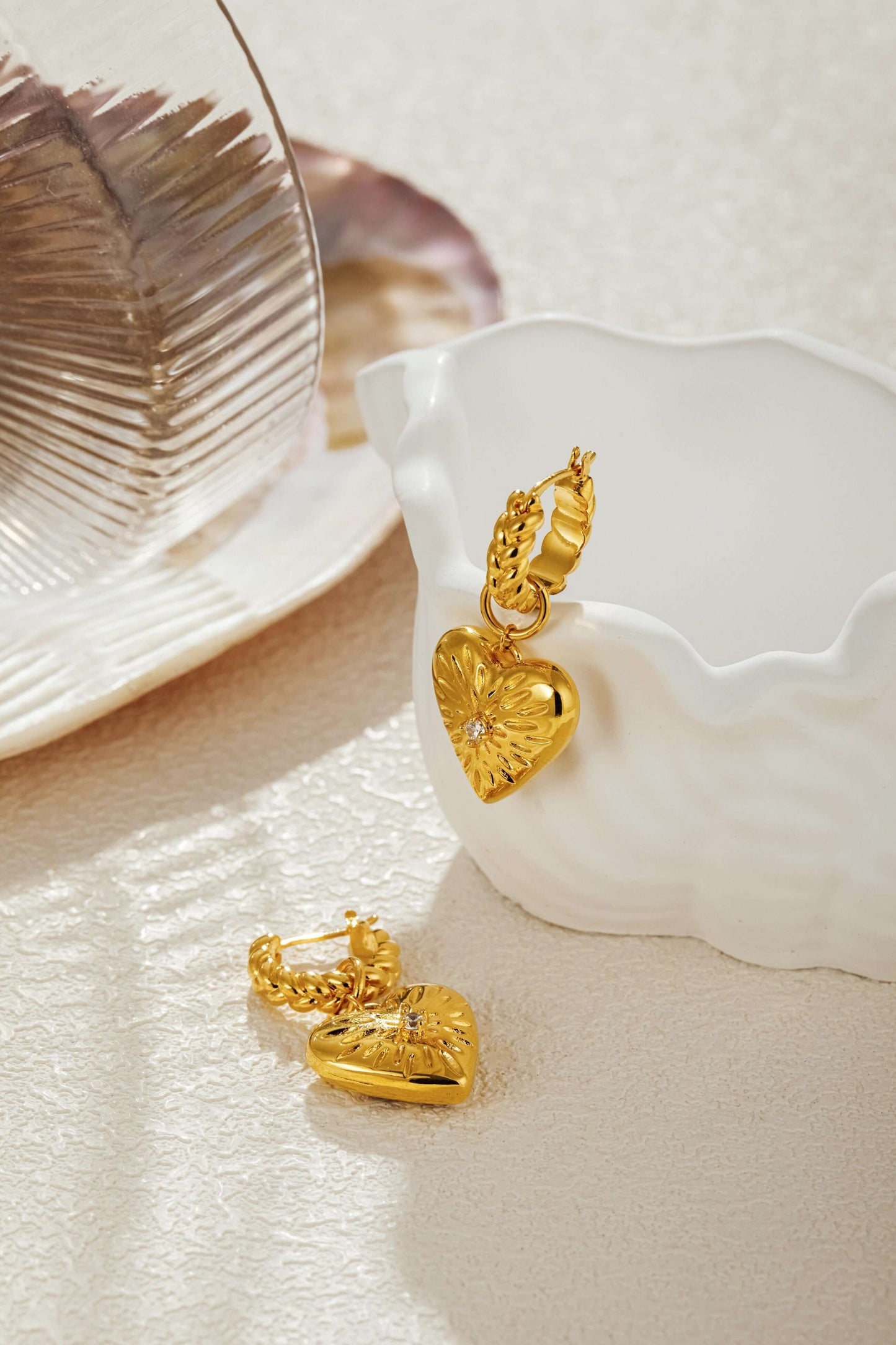 Gold-tone Amour Pendant Earrings with heart charm, starburst design, sparkling crystal, and textured hoops by SUIHE Jewelry.