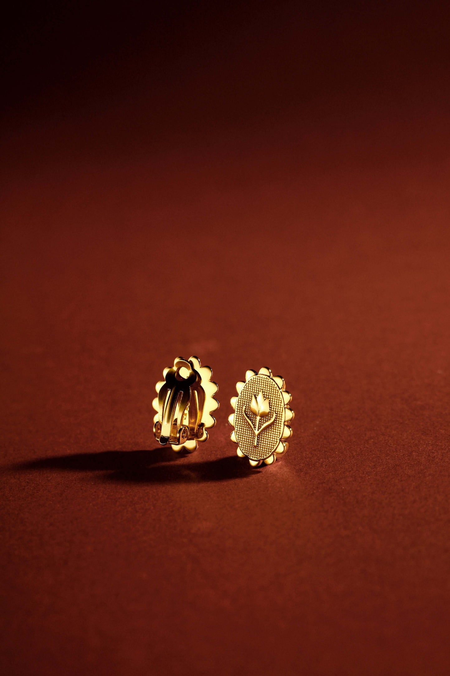 SUIHE Jewelry 18k Gold Vermeil Golden Tulip Clip Earrings on brown background, embodying elegance and versatility.