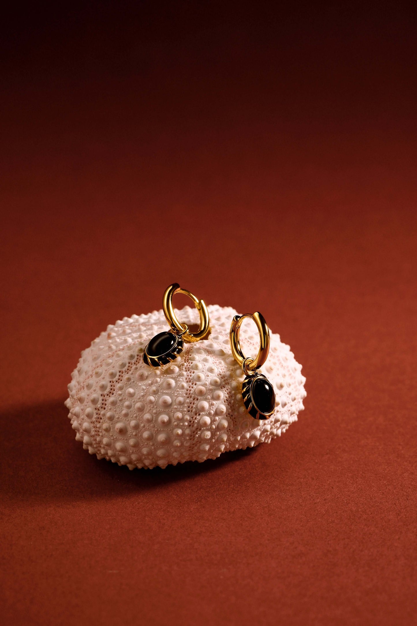 Alt Tag: "Eclipse" Black Onyx and Enamel Earrings by SUIHE Jewelry on Sea Urchin Display