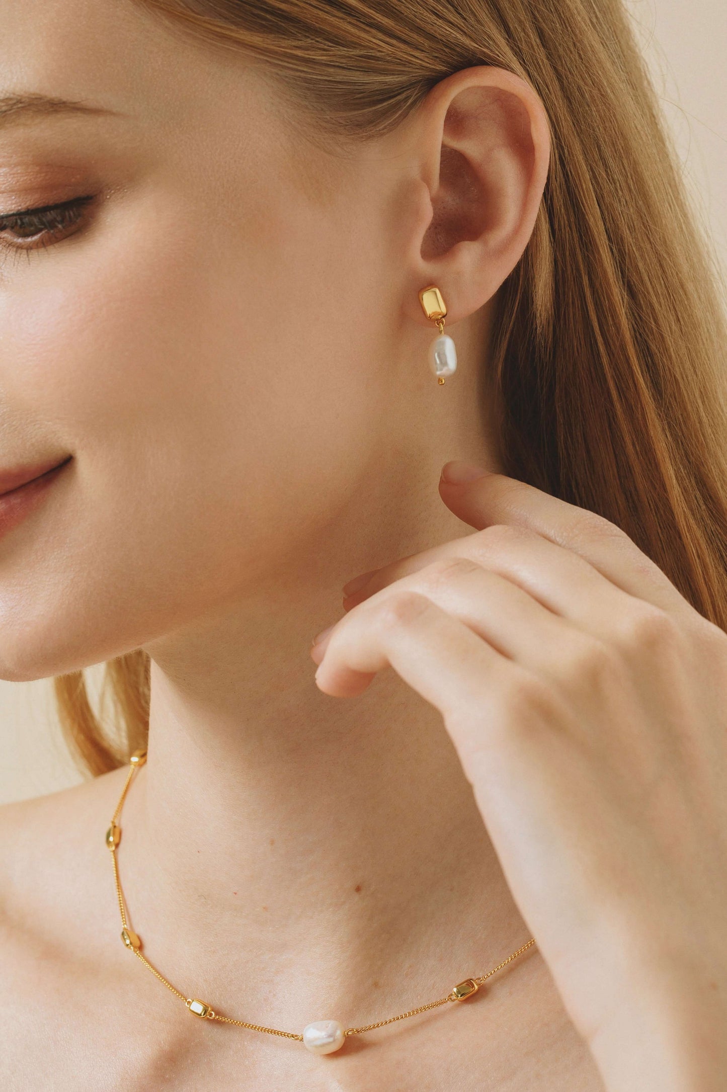 Close-up of model wearing "Jellybean" Baroque Pearl Earrings by SUIHE Jewelry, featuring irregular pearls and 18k gold vermeil.