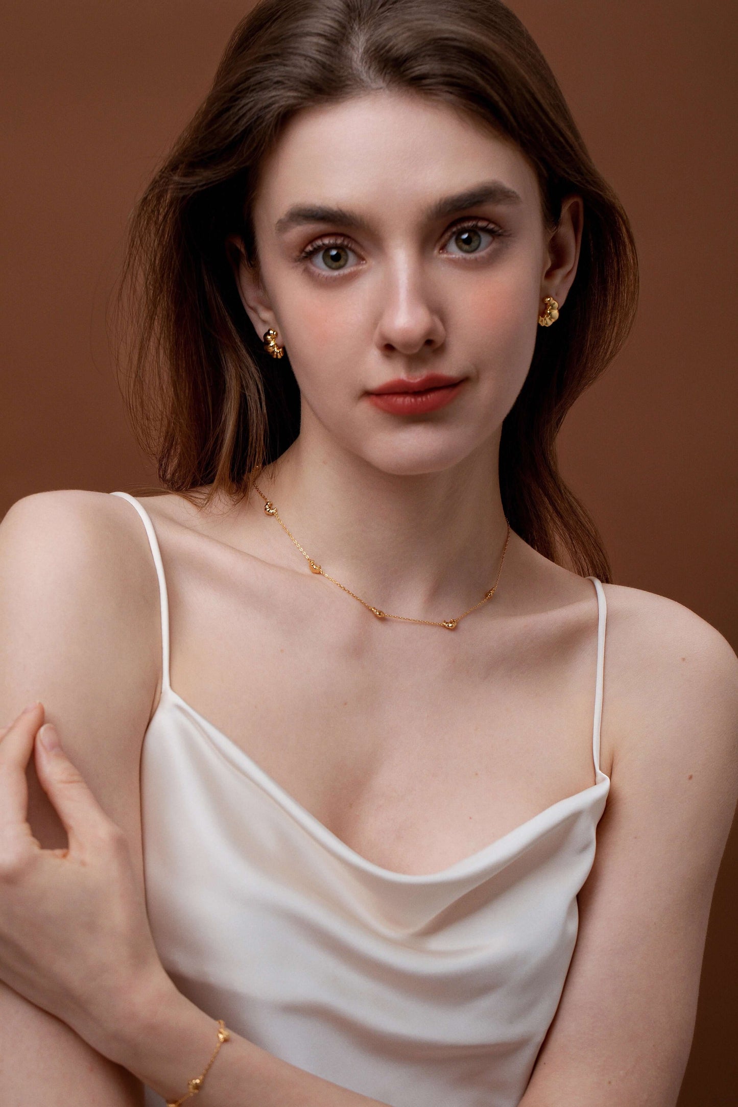 Woman wearing SUIHE Jewelry Croissant Mini Charm Necklace in 18k gold vermeil.