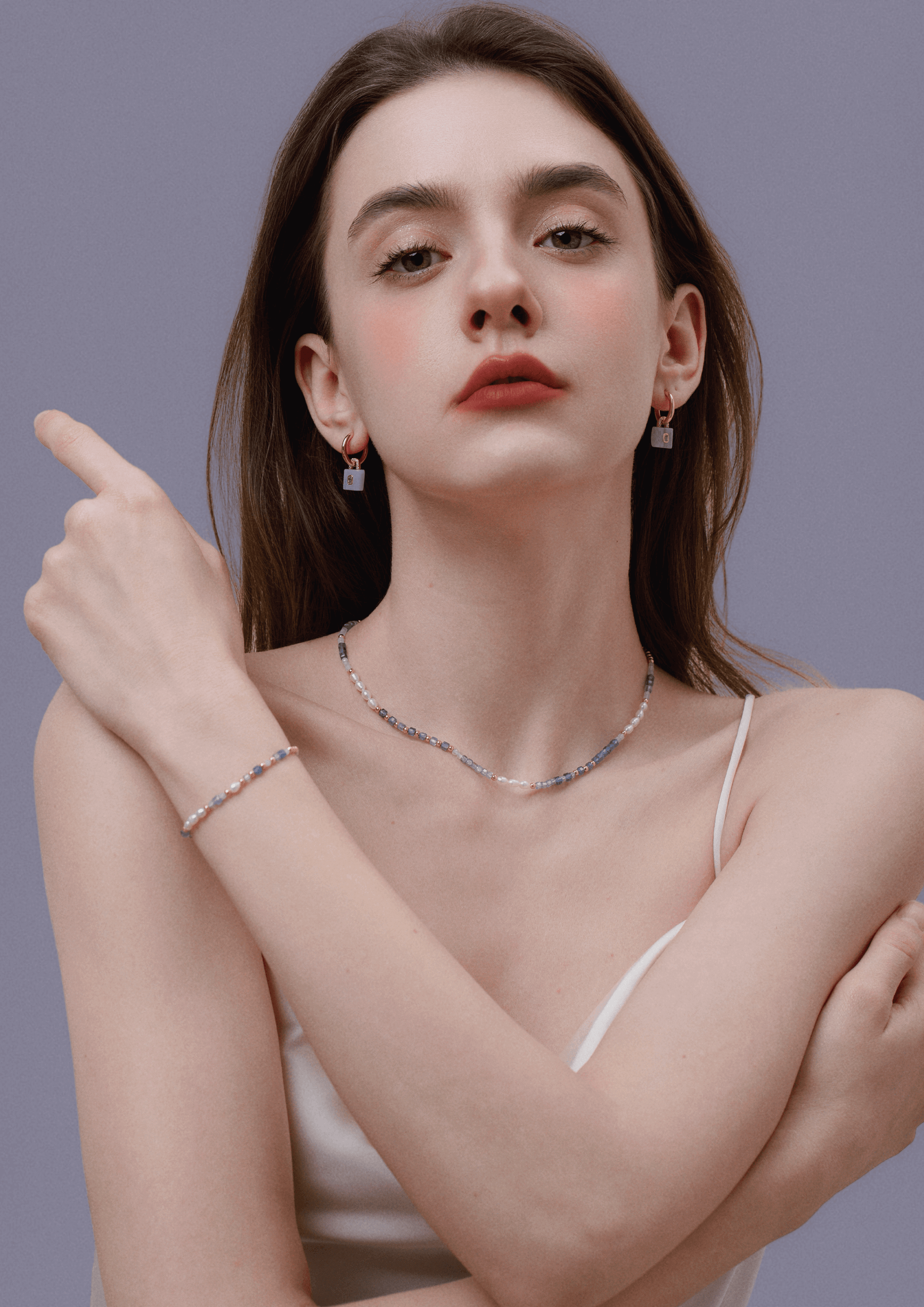 Woman wearing Ocean necklace with gemstones, pearls, and gold-plated beads by SUIHE Jewelry, elegant accessory for serene style.