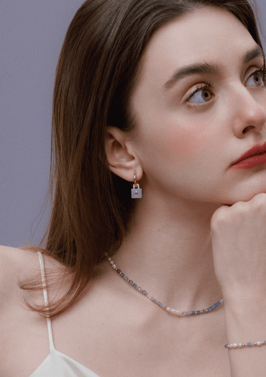 Woman wearing Ocean Natural Gemstone Bracelet and matching necklace, showcasing SUIHE Jewelry in soothing blue, lavender, and white tones.