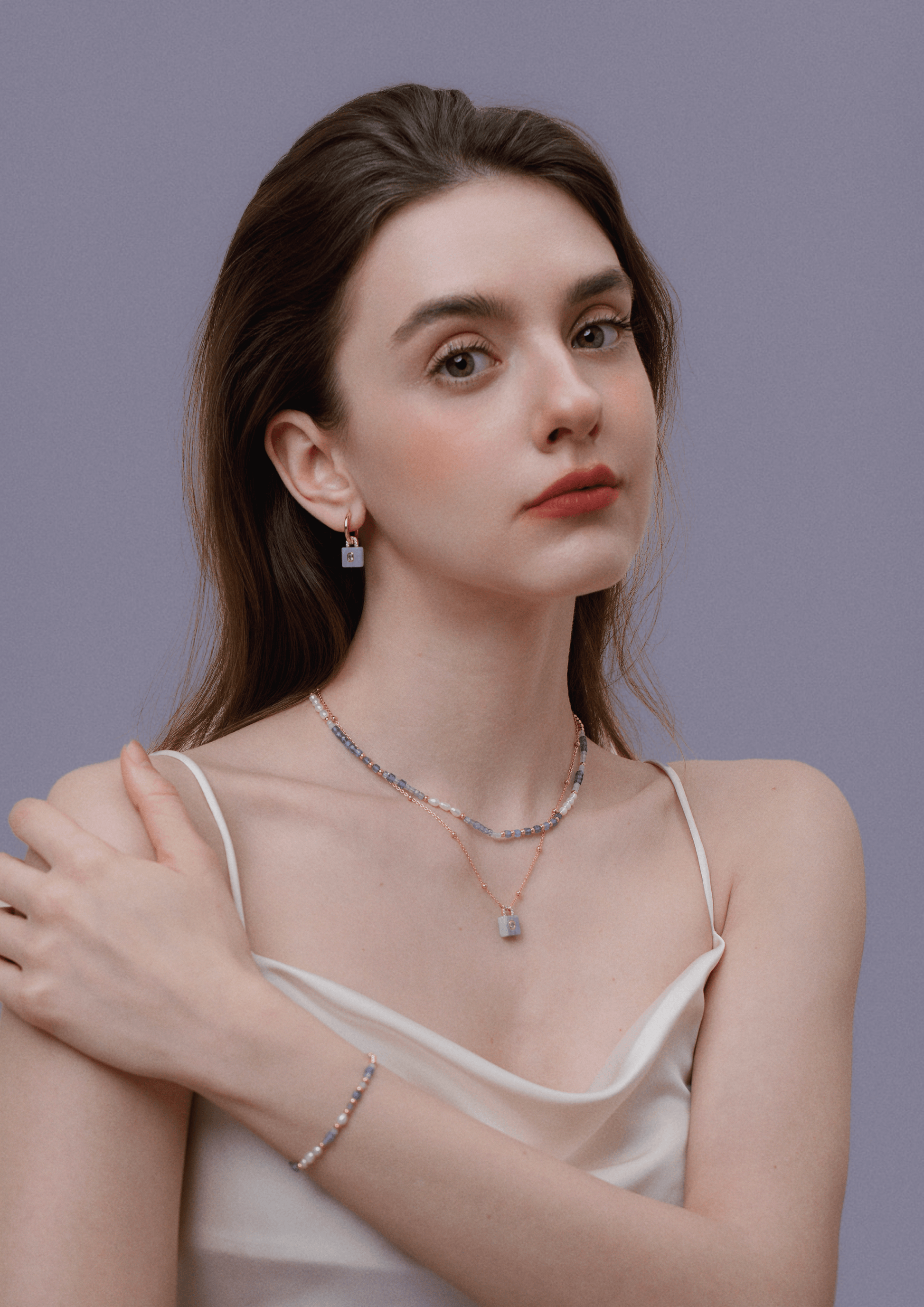 Woman wearing Ocean Natural Gemstone Necklace with pearls and gold-plated beads by SUIHE Jewelry.