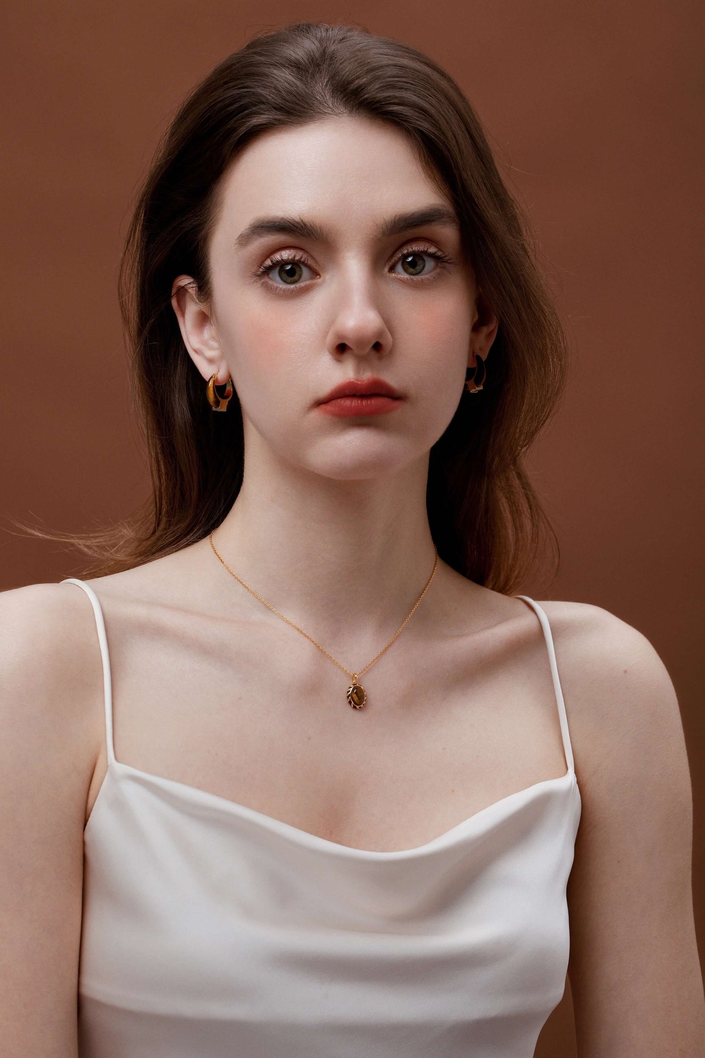 Woman wearing SUIHE Jewelry Mocha Tiger Eye Stone Necklace with gold vermeil chain, elegant accessory for day to night wear.