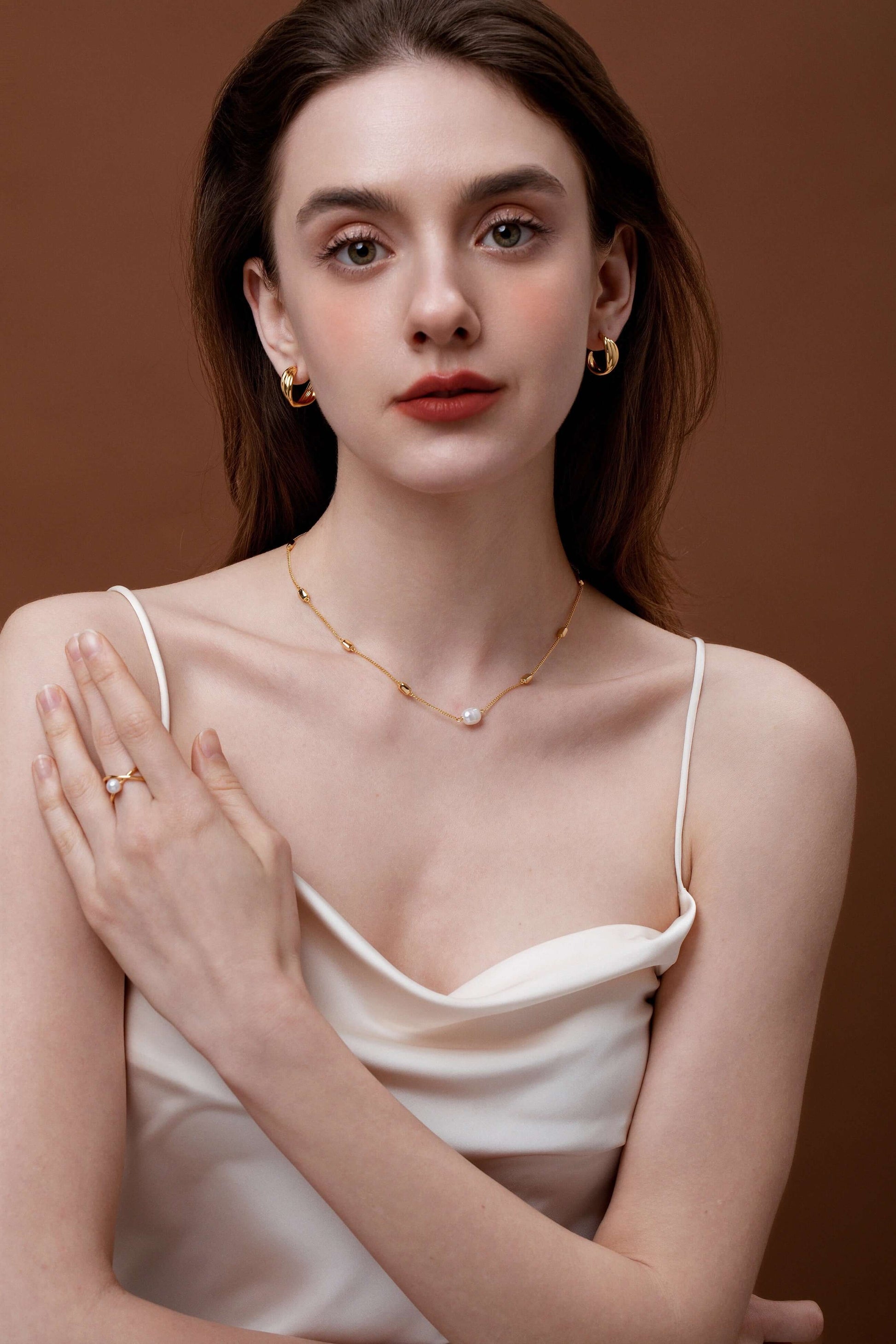 Woman wearing "Wavelet" Freshwater Pearl Ring and gold jewelry by SUIHE Jewelry, showcasing elegance and modern design style.