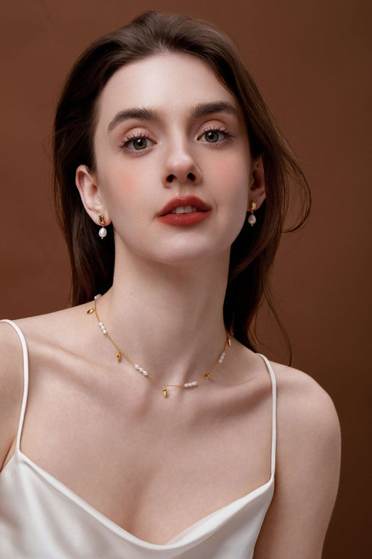 Woman wearing Candybean Pearl Necklace by SUIHE Jewelry with 5-6mm irregular pearls on gold-plated chain, elegant styling.