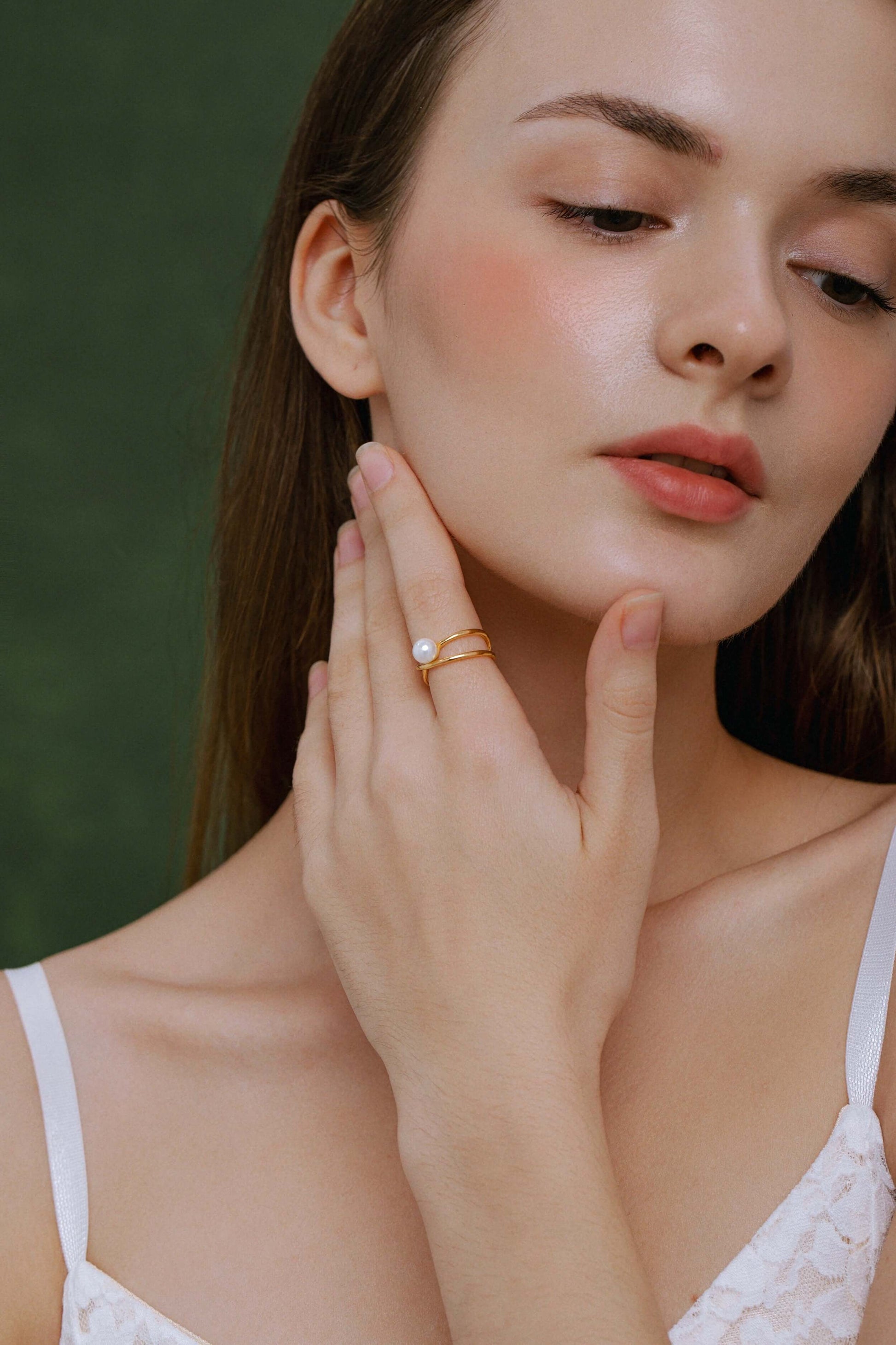 Woman wearing SUIHE Jewelry Wavelet Freshwater Pearl Ring in gold-tone metal showcasing elegance and modern design.