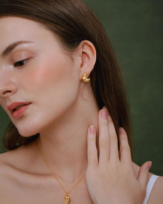 Woman wearing Croissant Stud Earrings in 18k Gold Vermeil by SUIHE Jewelry, showcasing Parisian elegance and style.