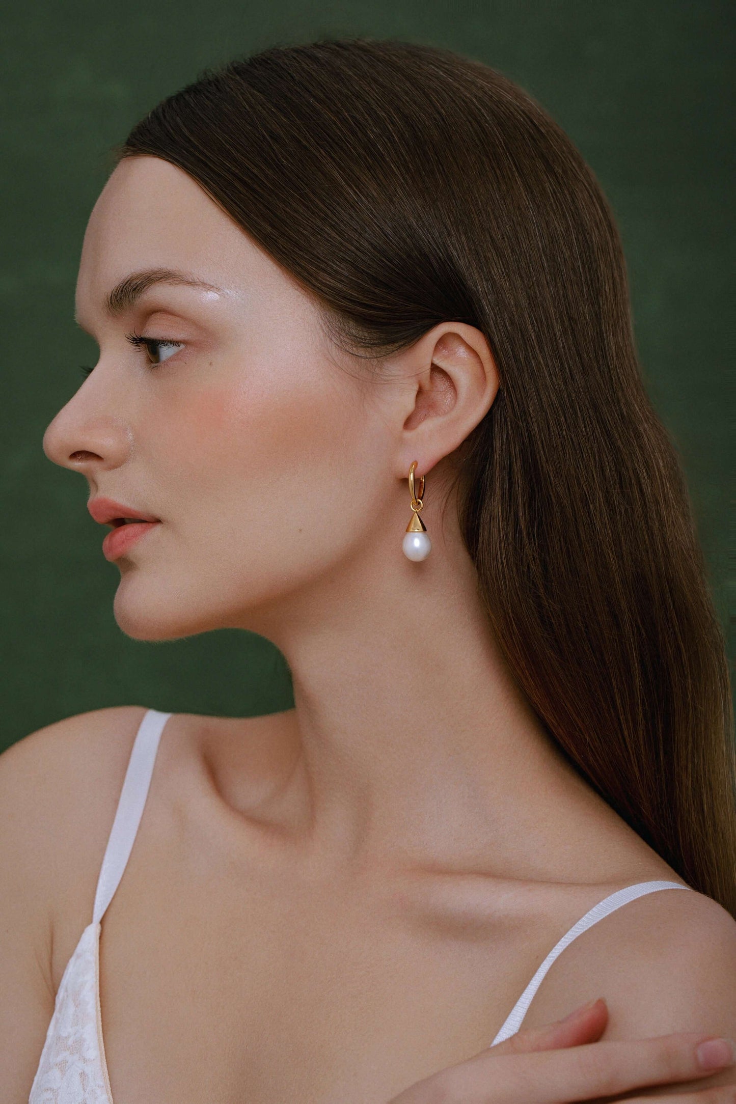 Woman wearing Dewdrop Freshwater Pearl Earrings by SUIHE Jewelry, featuring gold-plated sterling silver and elegant natural pearls.