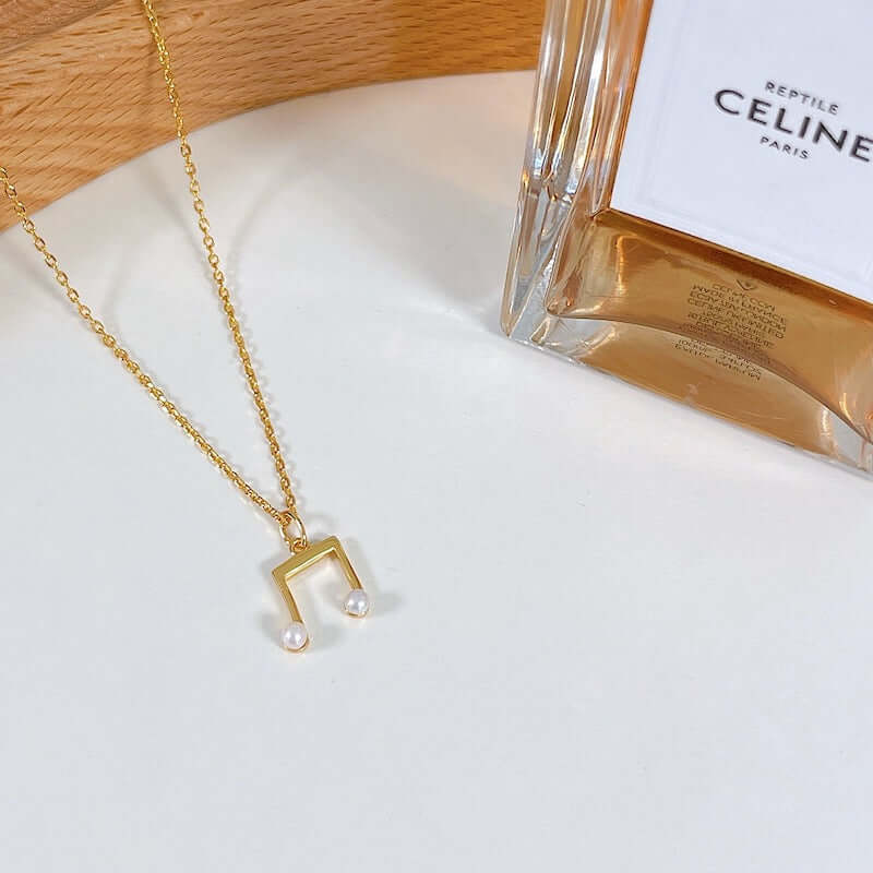 SUIHE Jewelry 'Melody' Necklace in 18k Gold Vermeil with freshwater pearls, showcasing delicate elegance and subtle charm.