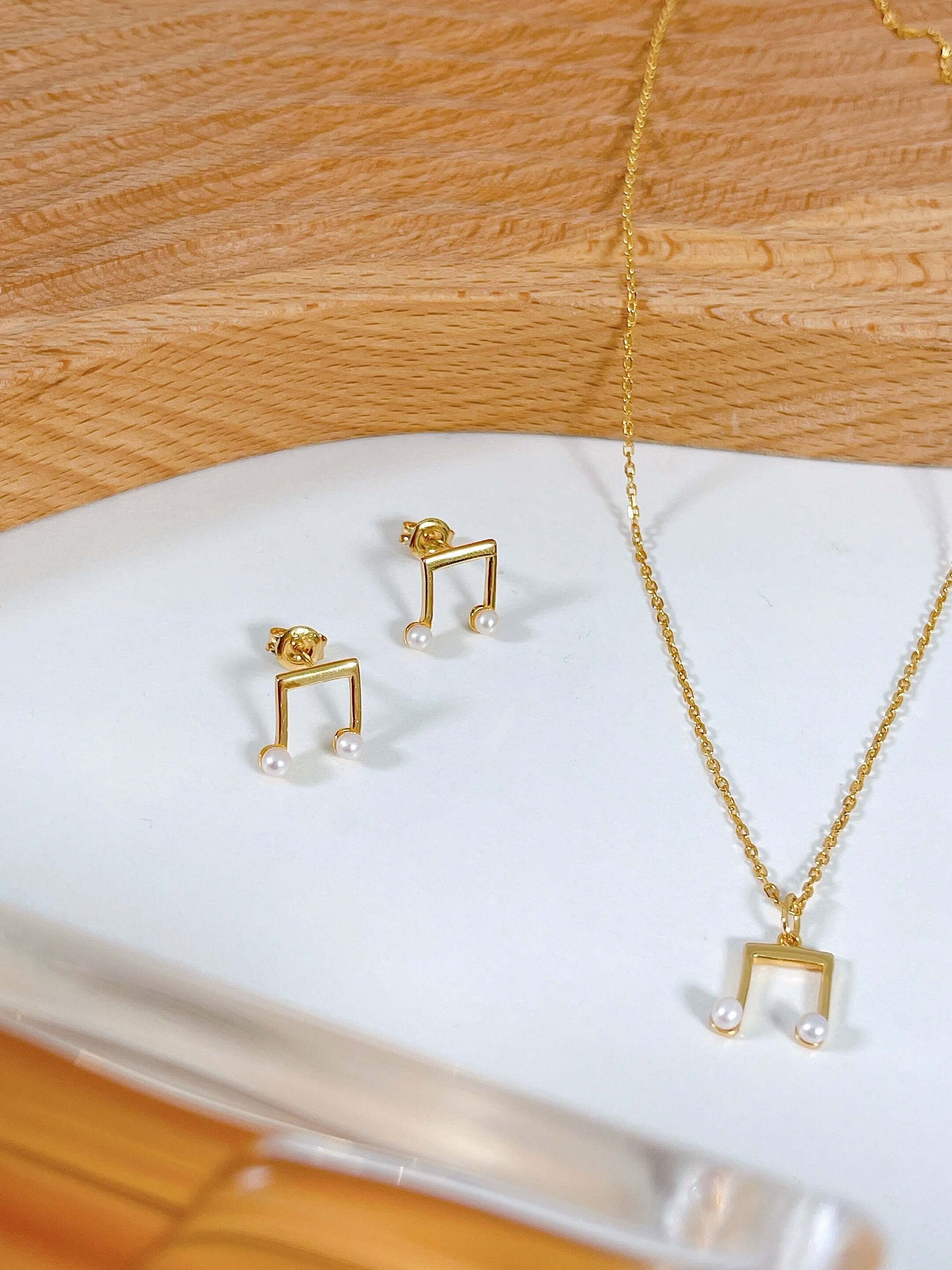 "Melody" earrings in 18k Gold Vermeil with freshwater pearls by SUIHE Jewelry, displayed with matching necklace on a white surface.