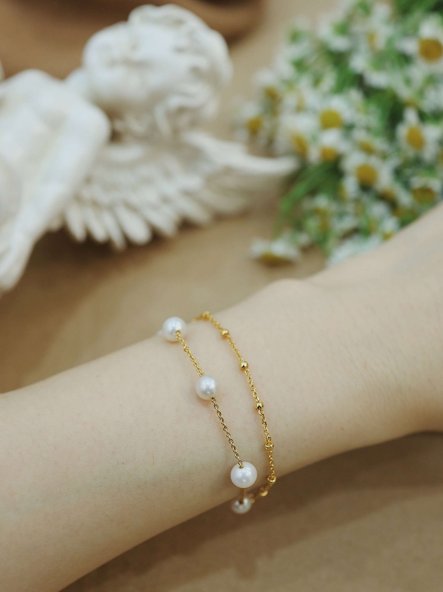 Elegant gold vermeil bracelet with freshwater pearls on wrist, "Perfect Pearl" by SUIHE Jewelry.