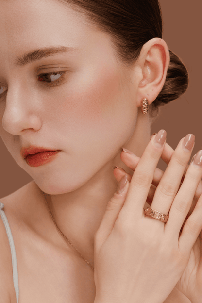 Woman wearing Bread Platter Ring with croissant, pretzel and baguette charms, in 18k gold vermeil, styled with matching earrings and natural look.