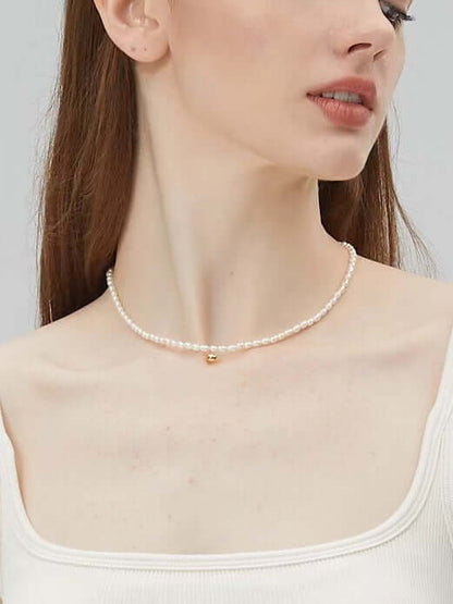 Model wearing Celestia Freshwater Pearl Necklace by SUIHE Jewelry, featuring 3-4mm pearls and 18k gold vermeil on sterling silver.