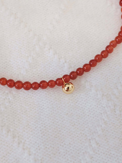 Lucky Red Agate Gemstone Bracelet with 18k Gold Vermeil, by SUIHE Jewelry, on textured white background.
