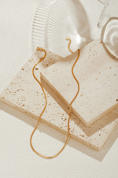 Classic Necklace by SUIHE Jewelry in 18k gold vermeil over sterling silver, displayed on textured stone for an elegant look.