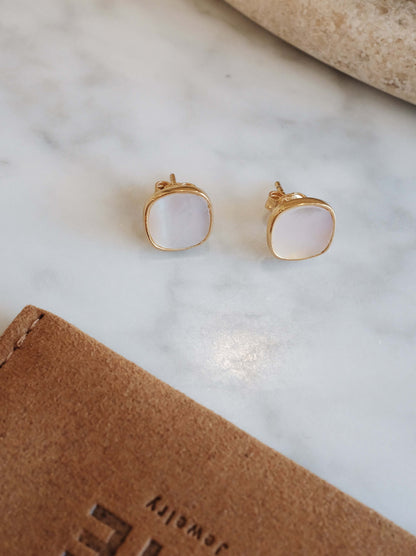 Moonlight Mother-of-Pearl Stud Earrings by SUIHE Jewelry in 18k Gold Vermeil, showcasing delicate iridescent design on marble surface.