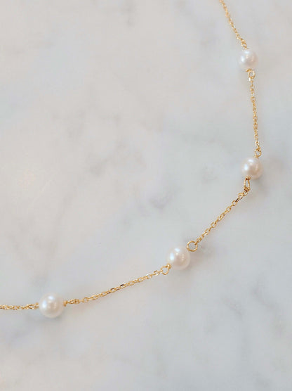 Delicate Akoya pearl necklace by SUIHE Jewelry, featuring lustrous pearls on a gold chain, capturing celestial elegance.