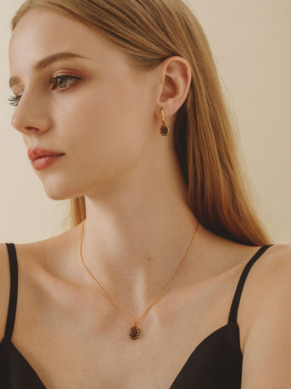 Woman wearing SUIHE Jewelry "Mocha" Pendant Earrings in 18k gold-plated silver with tiger's eye stones and yellow enamel.