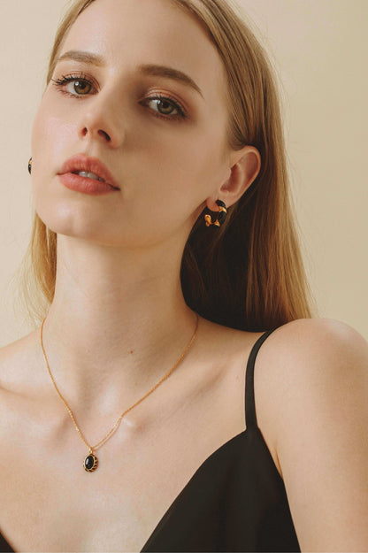 Model wearing "Eclipse" Black Onyx and Enamel Necklace by SUIHE Jewelry, showcasing elegance and intrigue with gold vermeil chain.
