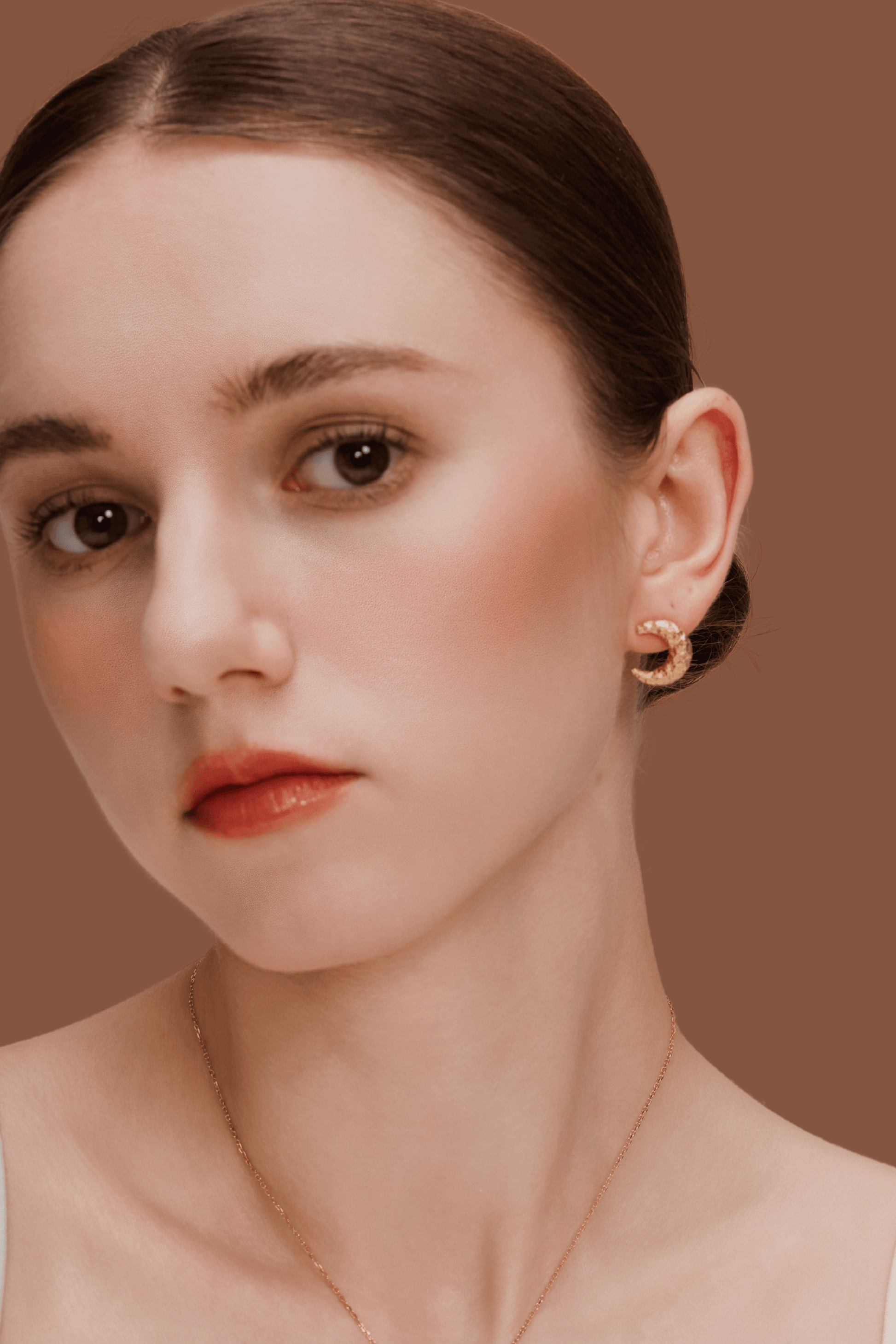 Model wearing gold-plated crescent Moon Earrings by SUIHE Jewelry showcasing textured, sculptural design for celestial and dreamer style.
