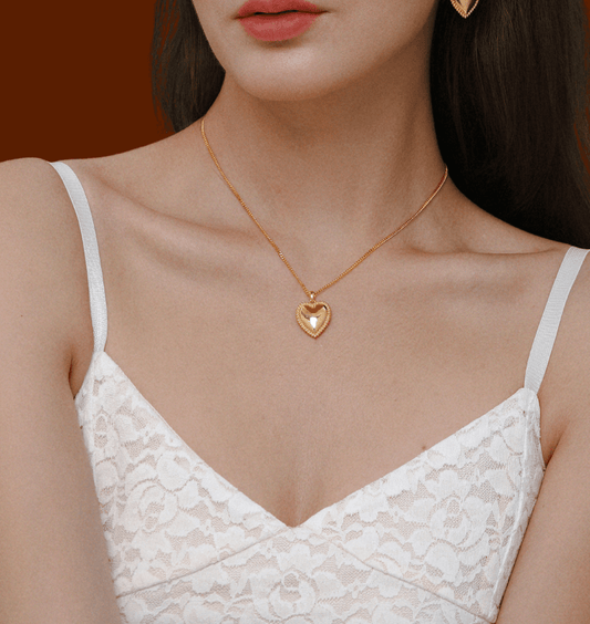 Gold-tone Adore Heart Charm Necklace by SUIHE Jewelry, featuring a polished heart pendant with beaded detailing on a sleek chain.