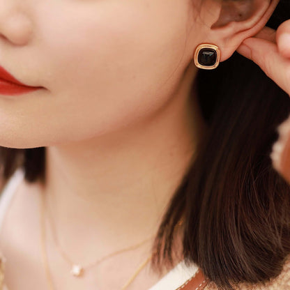 Woman wearing SUIHE Jewelry's "Nocturne" Black Onyx Square Earrings with 18k Gold Vermeil, showcasing elegance and style.