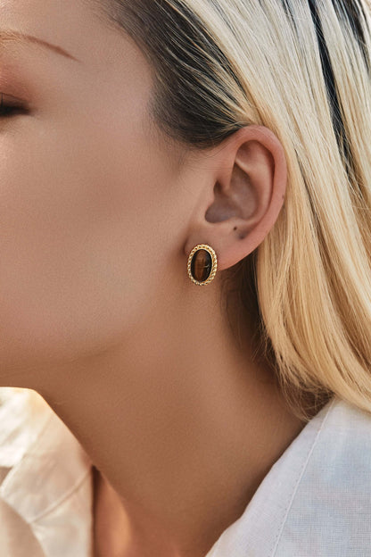 Close-up of woman wearing SUIHE Jewelry Amber Earrings in Tiger's Eye Stone and 18k Gold Vermeil, highlighting elegance and versatility.